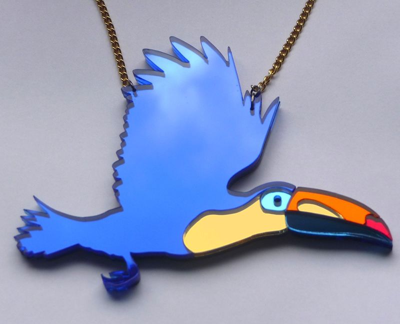 Mirrored_toucan_necklace_on_grey_BC